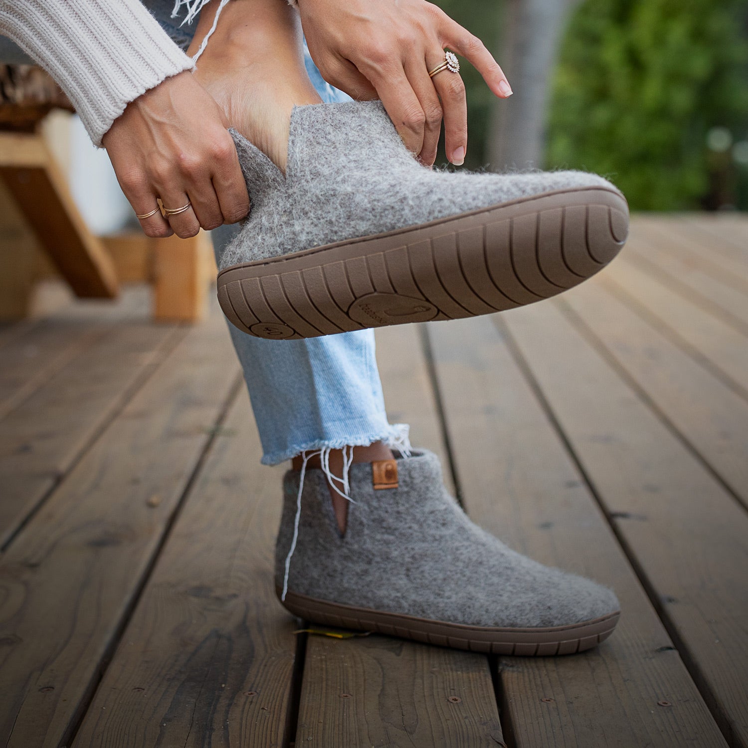 Close up photo of a pair of feet, modeling Baabushka's line of rubber-soled woolen booties.